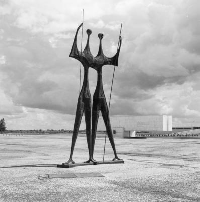 "Os Candangos" ou "Os Guerreiros", escultura de Bruno Giorgi. Ao fundo, o Museu Histórico de Brasília