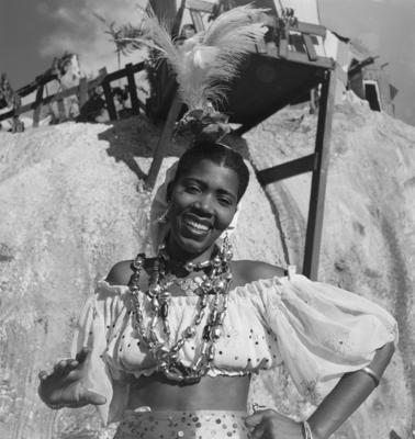 Mulheres fantasiadas em frente a uma decoração de rua no carnaval carioca