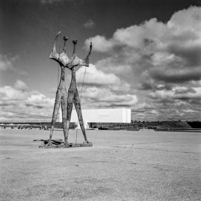"Os Candangos" ou "Os Guerreiros", escultura de Bruno Giorgi. Ao fundo, o Museu Histórico de Brasília